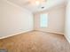 Bright bedroom featuring a ceiling fan and a window with natural light at 5156 Allison Way, Sugar Hill, GA 30518