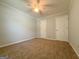 Neutral bedroom features carpet and two doors for closet and access at 5156 Allison Way, Sugar Hill, GA 30518
