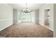 Inviting dining room with bright bay windows, chandelier, and neutral color palette, ideal for Gathering gatherings at 5156 Allison Way, Sugar Hill, GA 30518