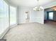 Lovely dining room with plush carpeting, chandelier, and views into the kitchen, perfect for entertaining and Gathering meals at 5156 Allison Way, Sugar Hill, GA 30518