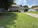 Charming two-story home with a lush green lawn and a long driveway leading to the garage at 5156 Allison Way, Sugar Hill, GA 30518