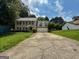 Charming two-story home with a lush green lawn and a cracked driveway leading to the garage at 5156 Allison Way, Sugar Hill, GA 30518