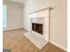 Close-up of a cozy marble fireplace with a white mantel in a spacious living room at 5156 Allison Way, Sugar Hill, GA 30518