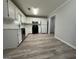 Modern kitchen featuring white cabinets, stainless steel dishwasher, and black appliances, ideal for home cooking at 5156 Allison Way, Sugar Hill, GA 30518