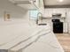 Kitchen counter with stainless sink, stylish faucet, and quartz countertops, blending style and functionality seamlessly at 5156 Allison Way, Sugar Hill, GA 30518