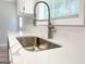Close-up of a modern kitchen sink with stylish faucet and bright quartz countertop, combining practicality with elegance at 5156 Allison Way, Sugar Hill, GA 30518