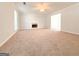 Spacious living room with neutral carpet, a fireplace, ceiling fan, and natural light at 5156 Allison Way, Sugar Hill, GA 30518