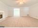 Spacious living room with neutral carpet, a fireplace, ceiling fan, and natural light at 5156 Allison Way, Sugar Hill, GA 30518