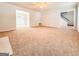 Expansive living room with neutral carpet and a fireplace and doorways to other rooms at 5156 Allison Way, Sugar Hill, GA 30518