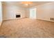 Spacious living room with neutral carpet, a fireplace, ceiling fan, and natural light at 5156 Allison Way, Sugar Hill, GA 30518