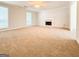 Large living room with a cozy fireplace, and an open doorway leading to the dining room at 5156 Allison Way, Sugar Hill, GA 30518