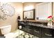 Half bath with modern black vanity, bowl sink, and decorative wall art at 543 Wynn Rd, Mcdonough, GA 30252