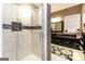 Modern bathroom featuring a tiled walk-in shower with decorative details and a dark vanity with marble counters at 543 Wynn Rd, Mcdonough, GA 30252
