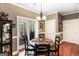 Cozy dining area with hardwood floors, stylish lighting, and glass doors to the outdoor patio at 543 Wynn Rd, Mcdonough, GA 30252