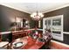 Elegant dining room with stylish lighting, wainscoting, and a large table for gatherings at 543 Wynn Rd, Mcdonough, GA 30252