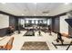 Home gym features various exercise equipment, a mirrored wall, and carpeted flooring under a standard drop ceiling at 543 Wynn Rd, Mcdonough, GA 30252