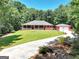 Stunning red brick house features a detached garage, long driveway, and front porch at 543 Wynn Rd, Mcdonough, GA 30252