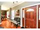 Inviting foyer with hardwood floors, a seating bench, and a beautiful front door at 543 Wynn Rd, Mcdonough, GA 30252