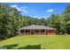 Well-maintained red brick home with a spacious front yard and a welcoming covered porch at 543 Wynn Rd, Mcdonough, GA 30252