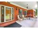 Charming brick front porch with seating, a hammock, and stylish decor for relaxing outdoor living at 543 Wynn Rd, Mcdonough, GA 30252