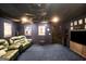 Home theater room with dark blue walls, a large screen, recliner couches and a ceiling fan for added comfort at 543 Wynn Rd, Mcdonough, GA 30252