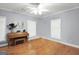 Bright living room with hardwood floors, a piano, and plenty of natural light at 543 Wynn Rd, Mcdonough, GA 30252