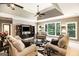 Spacious living room with tray ceilings, a ceiling fan, and large windows for ample natural light at 543 Wynn Rd, Mcdonough, GA 30252