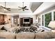 Comfortable living room featuring ceiling fans, large windows, and built-in storage for modern living at 543 Wynn Rd, Mcdonough, GA 30252
