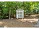 Well-maintained shed with painted siding and double doors on a wooded lot at 543 Wynn Rd, Mcdonough, GA 30252