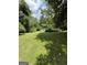 Expansive backyard with lush lawn and surrounding trees at 402 Stone St, Oxford, GA 30054