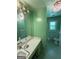 Unique bathroom with bright green tile and patterned wallpaper at 402 Stone St, Oxford, GA 30054