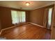 Bedroom featuring wood floors, window, closet, and warm brown walls at 402 Stone St, Oxford, GA 30054