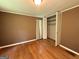 Bedroom with wood floors, neutral walls, closet, window at 402 Stone St, Oxford, GA 30054