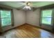 Bright bedroom with hardwood floors and natural light from two windows at 402 Stone St, Oxford, GA 30054
