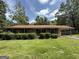 Charming brick home with a lush green lawn and a convenient covered carport at 402 Stone St, Oxford, GA 30054