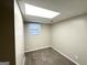 Cozy basement area featuring updated paneling, carpet flooring and a window at 5670 Bob White Ln, Douglasville, GA 30135