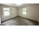 Bedroom featuring neutral colored walls and carpet, and two windows at 2500 Brentwood Rd, Decatur, GA 30032