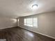 Bright living room featuring laminate floors, a large window, and neutral walls at 2500 Brentwood Rd, Decatur, GA 30032