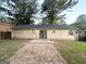Home's backyard with concrete patio and large trees at 410 Tarragon Sw Way, Atlanta, GA 30331