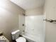 Clean bathroom with white tiled shower-tub combination, granite countertop, and neutral walls at 410 Tarragon Sw Way, Atlanta, GA 30331