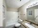 Neat bathroom with a white tiled shower-tub combination, granite countertop, and ample lighting at 410 Tarragon Sw Way, Atlanta, GA 30331