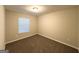 Cozy bedroom featuring neutral paint, carpet, and a window providing ample natural light at 410 Tarragon Sw Way, Atlanta, GA 30331