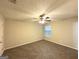 Cozy bedroom featuring a ceiling fan, neutral-colored walls, and soft carpeting for comfort at 410 Tarragon Sw Way, Atlanta, GA 30331