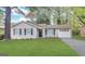 Charming single-story home with manicured lawn, neutral siding, black shutters, and an attached garage at 410 Tarragon Sw Way, Atlanta, GA 30331