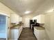 Well-lit kitchen featuring white cabinetry, granite countertops, and stainless steel appliances at 410 Tarragon Sw Way, Atlanta, GA 30331