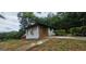 Property exterior showing painted brick, and a partial view of the lawn and driveway at 4916 Campbellton Sw Rd, South Fulton, GA 30331