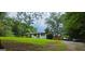 Scenic exterior of home with deck and lush greenery, offering a serene, private setting at 4916 Campbellton Sw Rd, South Fulton, GA 30331