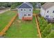 Aerial view of a gray home with a wooden deck and a fenced backyard with green grass at 583 Whitaker Nw St, Atlanta, GA 30318