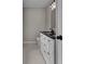 Charming bathroom featuring a vanity with black countertop, white cabinets, and black hardware at 583 Whitaker Nw St, Atlanta, GA 30318