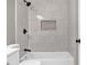 Updated bathroom with a white vanity, toilet, and shower-tub combination featuring marble-look tile at 583 Whitaker Nw St, Atlanta, GA 30318